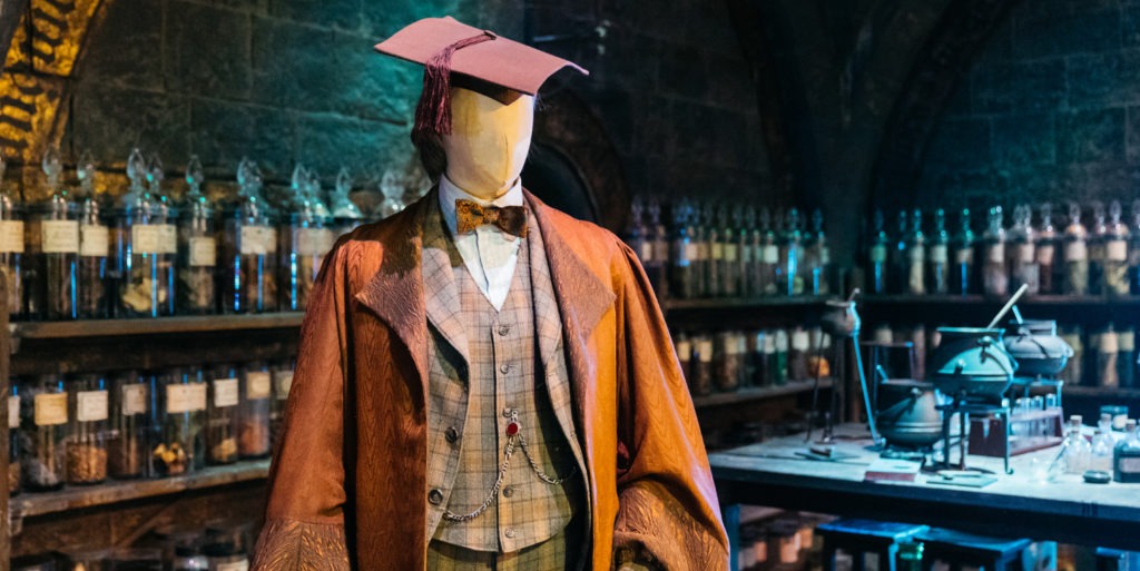 Slughorn in Potions classroom mid shot