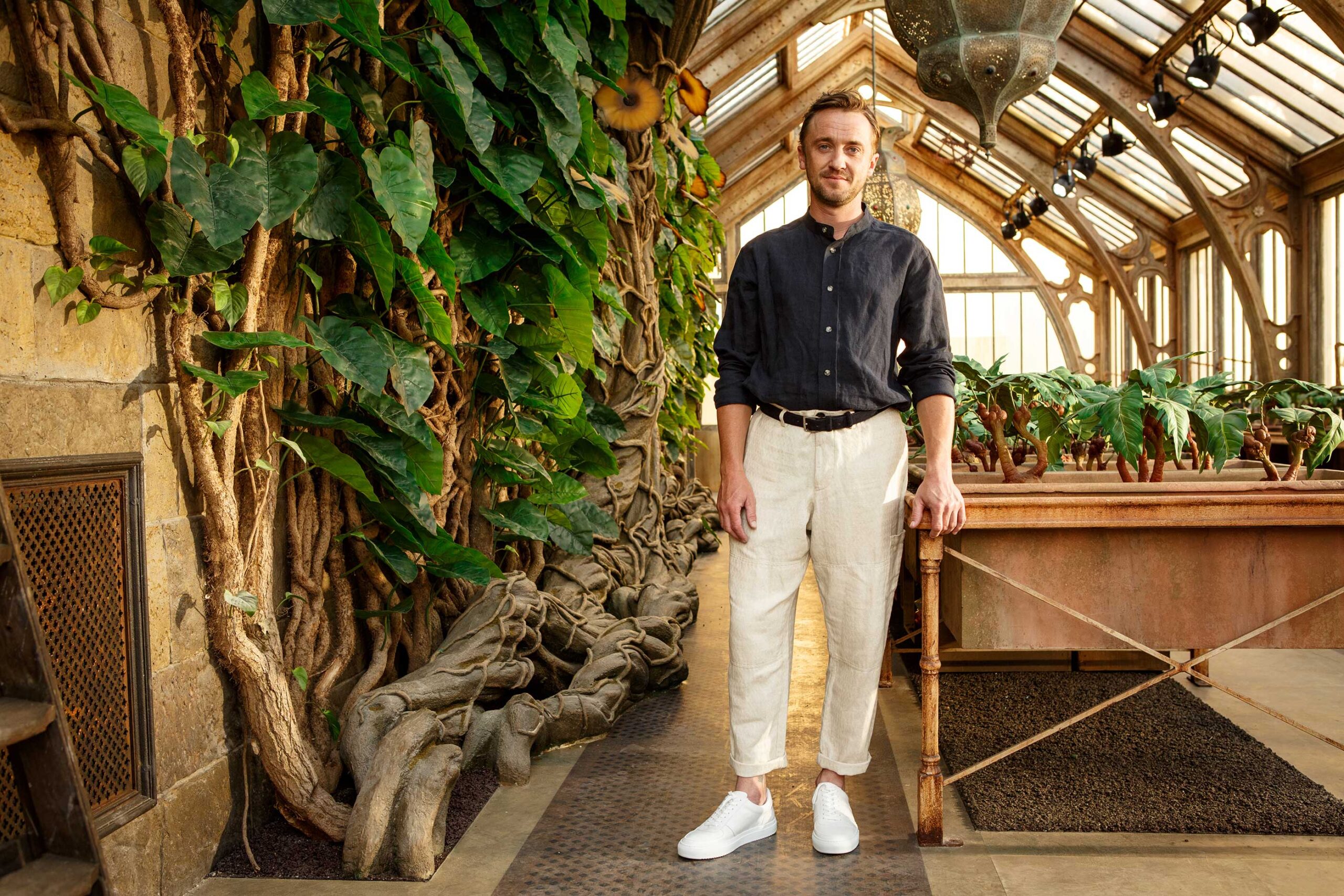 Tom Felton, who played Draco Malfoy, inside Professor Sprout's greenhouse set at Warner Bros. Studio Tour London